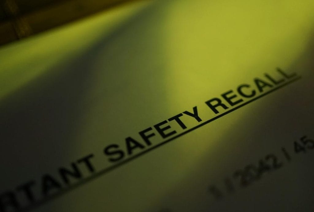 Closeup of the words "product safety recall" printed on paper, tinted green, but not an image from actual children's product recalls in Canada