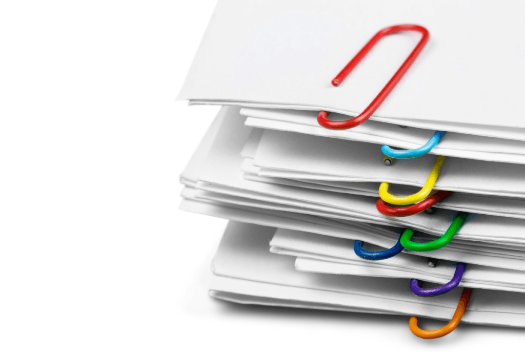 The complexity of GPSR compliance for baby carriers is implied by a stack of papers grouped by colored paper clips.