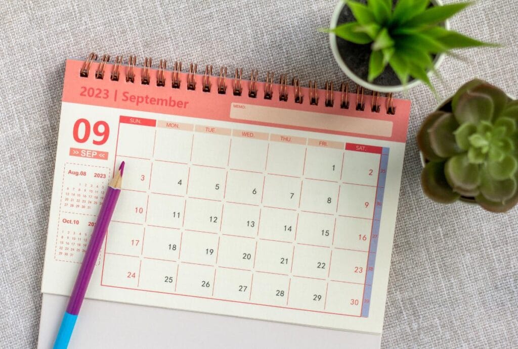 A calendar with a pencil evokes creating a schedule for testing baby carriers and slings